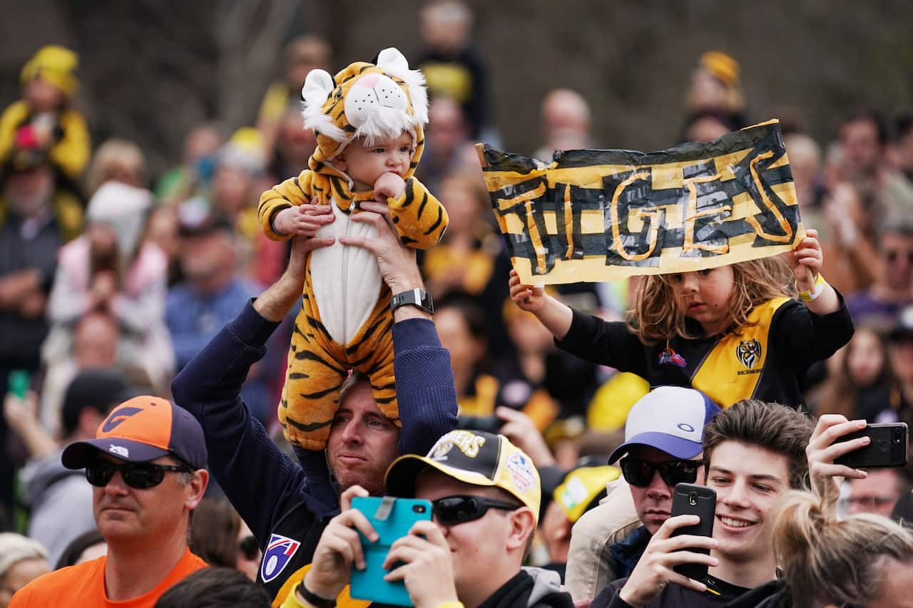 Tigers show their support during the AFL Grand Final Parade in Melbourne, Friday, September 27, 2019. (AAP Image/Michael Dodge) NO ARCHIVING