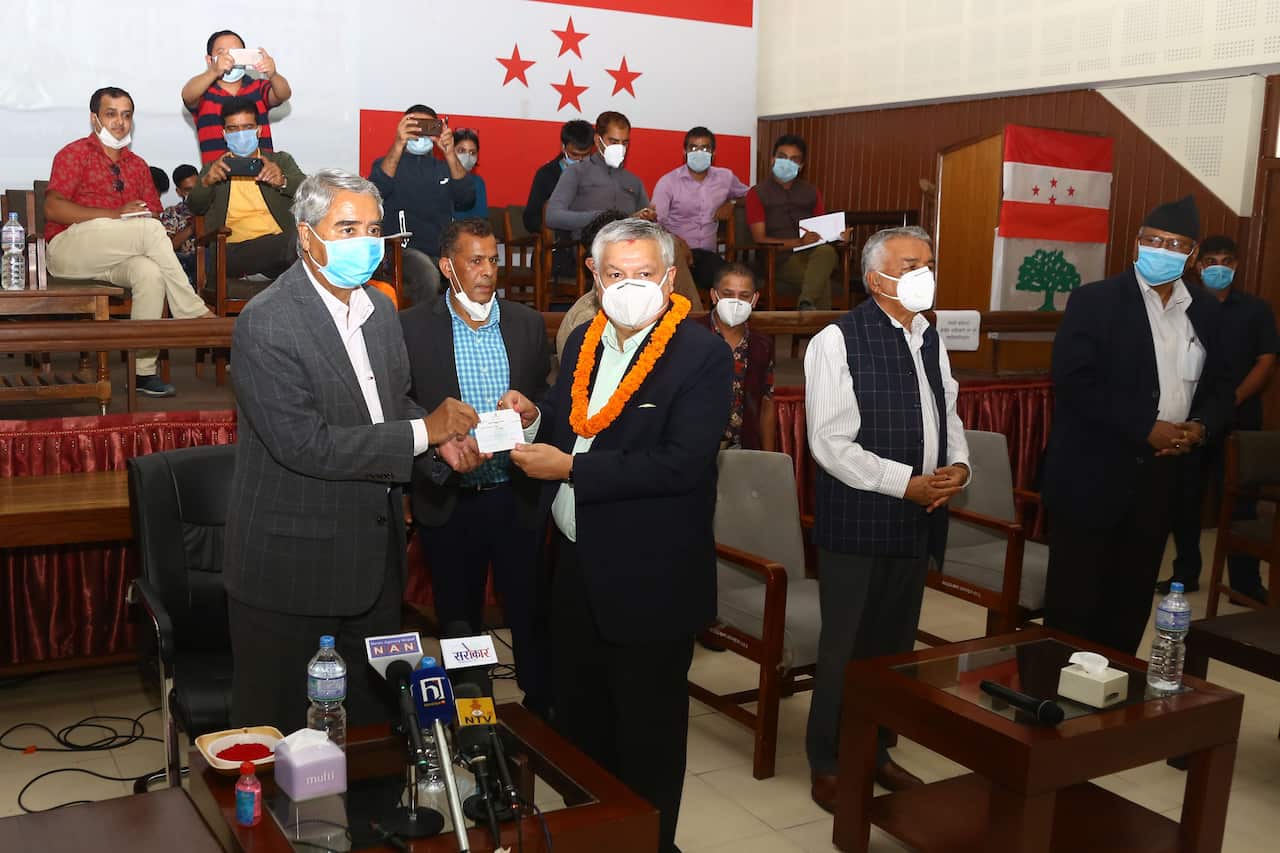Former RPP politicians who joined Nepali Congress being officially welcomed by leader Sher Bahadur Deuba