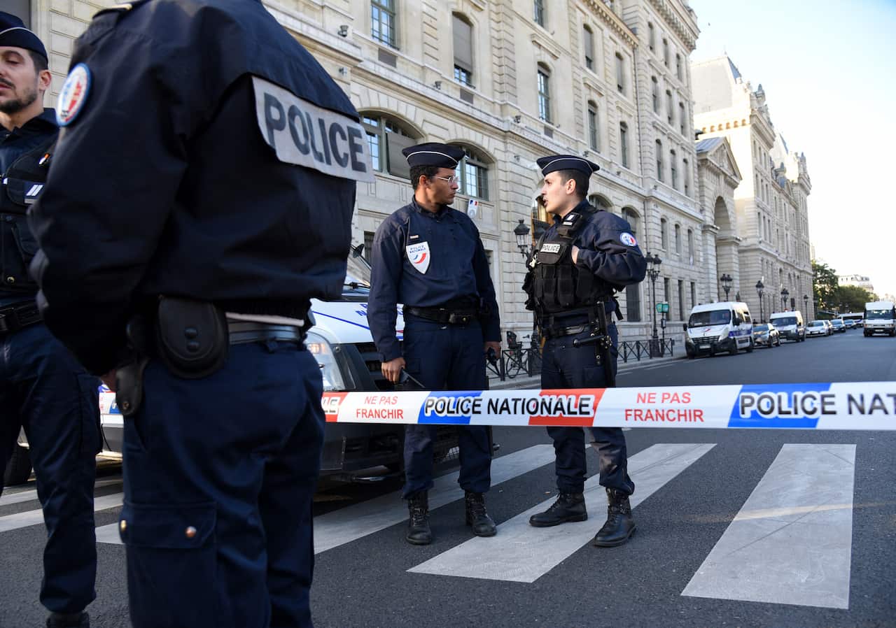 Police and military personnel block the bridge near Paris Police headquarters after four officers were killed in a knife attack on October 3, 2019 in Paris