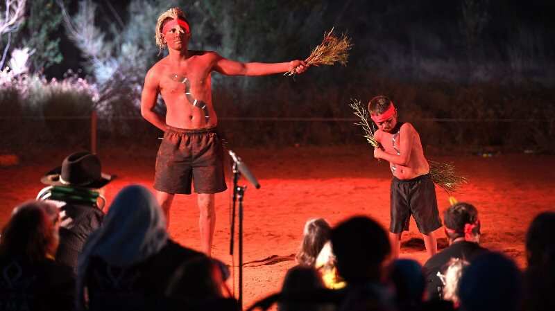 Indigenous Anangu perform during a ceremony marking the permanent ban on climbing Uluru, also known as Ayers Rock, at Uluru-Kata Tjuta National Park in Australia's Northern Territory on October 27, 2019. 