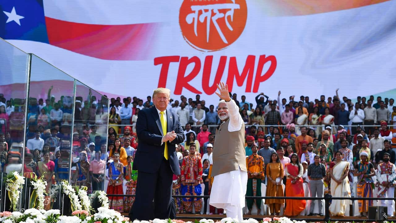 US President Donald Trump (L) looks on as India's Prime Minister Narendra Modi waves during 'Namaste Trump' rally at Sardar Patel Stadium in Motera, on the outskirts of Ahmedabad, on February 24, 2020.