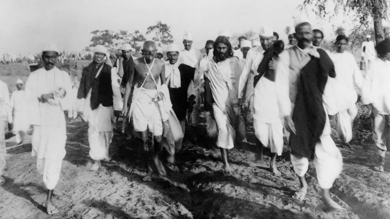 MOHANDAS GANDHI (1869-1948). Hindu nationalist and spiritual leader. On the Salt March, 1930.