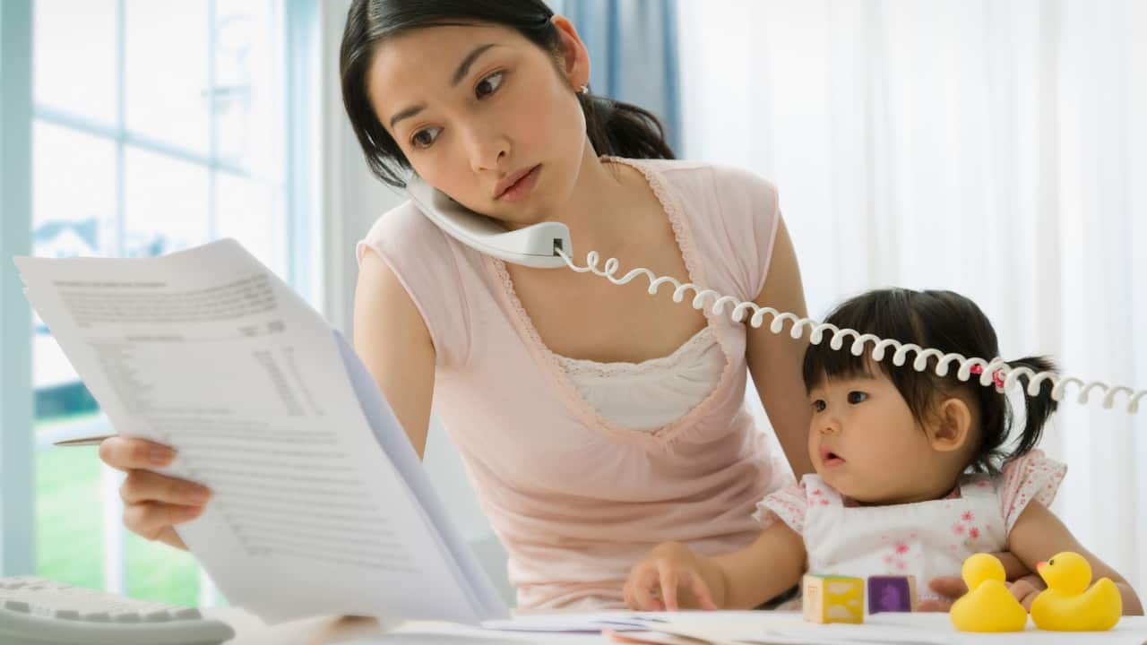 Young mother on the phone with a child 