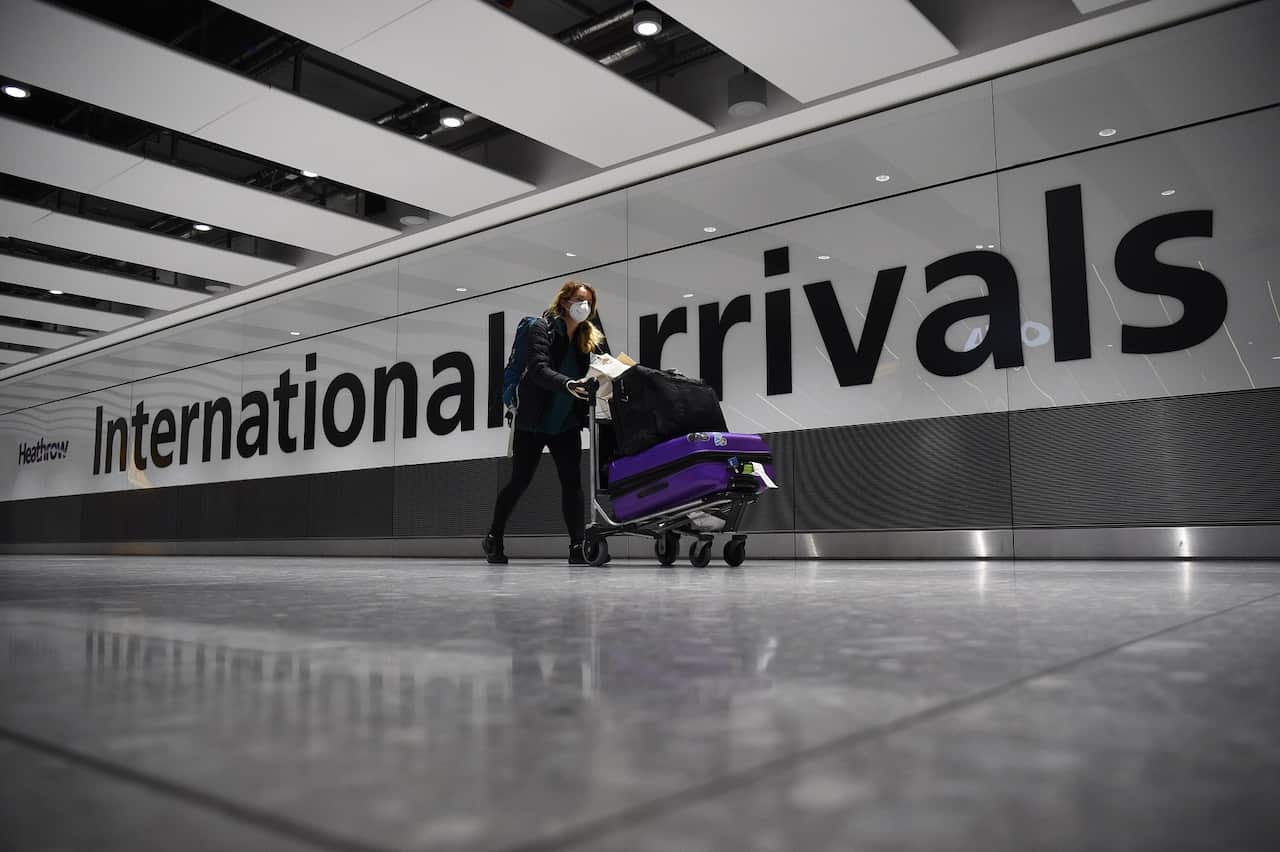 passenger pushing luggage through the Arrival Hall of Terminal 5 at London's Heathrow Airport. 