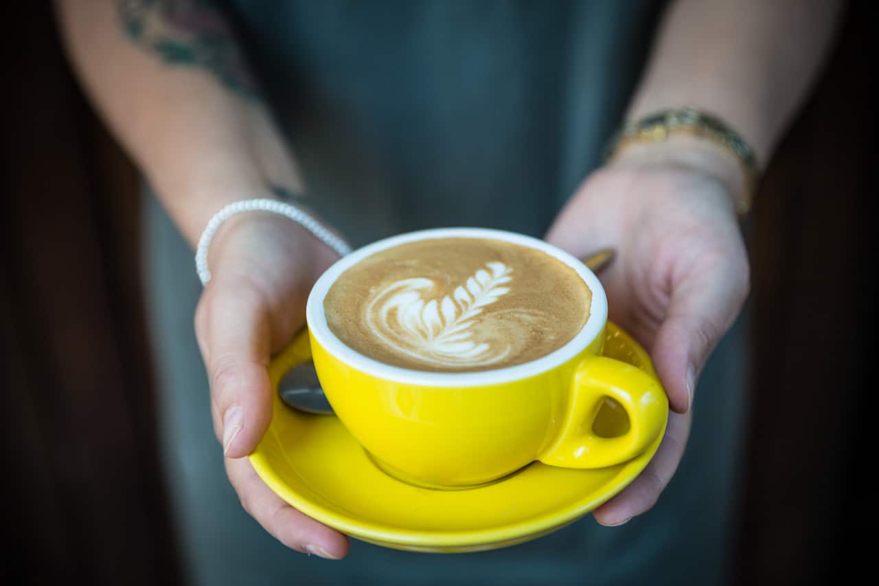 A yellow cup of latte