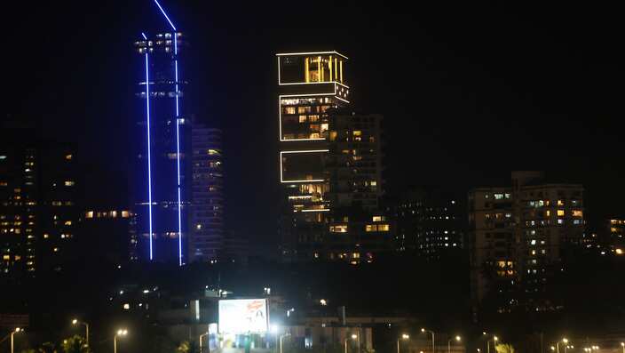 The house of Reliance Industries Chairman Mukesh Ambani is seen illuminated, center, ahead of the wedding of his daughter Isha, in Mumbai, India.