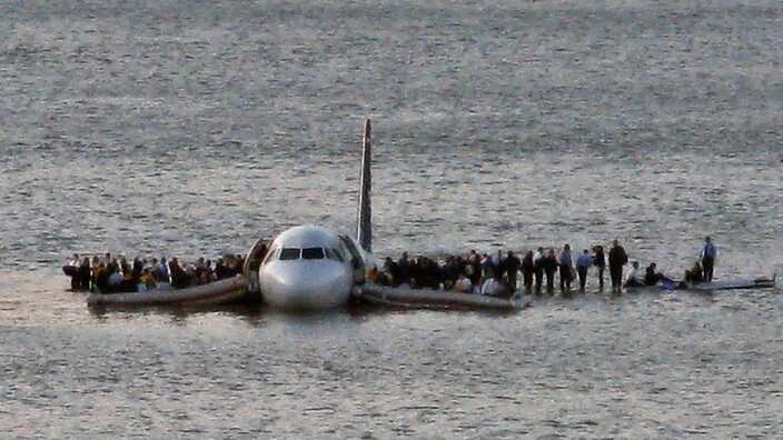 n this Thursday Jan. 15, 2009 file photo, airline passengers wait to be rescued on the wings of a US Airways Airbus 320 jetliner that safely ditched in the frigid waters of the Hudson River in New York, after a flock of birds knocked out both its engines.