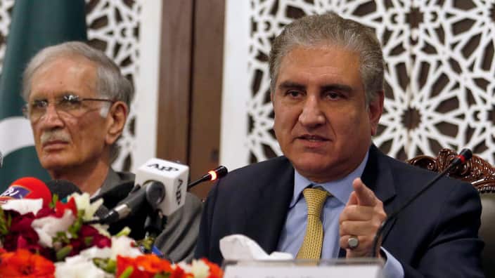 Pakistani Foreign Minister Shah Mahmood Qureshi, right, gives a press conference after a recent Indian airstrike, in Islamabad, Pakistan, 