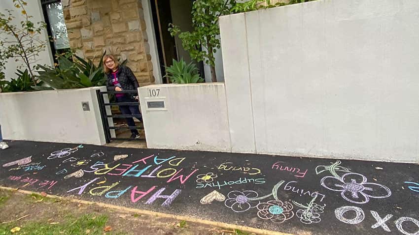 Iman Allaf stands next to her decorated sidewalk 