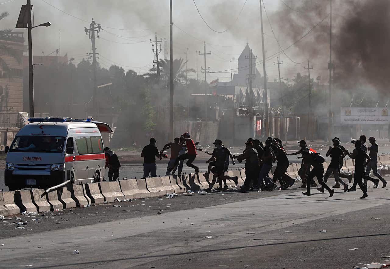 An injured protestor is rushed to the hospital after being shot during a demonstration in Baghdad, Iraq, Friday