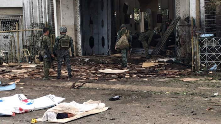 Filipino soldiers gather evidences next to the covered bodies of victims in front of a church following explosions in Jolo city, Sulu, Philippines, 27 Jan 2019.