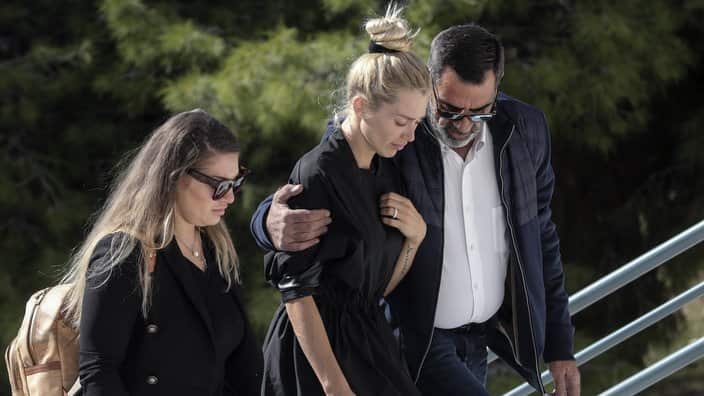 Viktoria Karyda, center, the wife of slain Greek Australian John Macris arrives at an Orthodox church for his funeral ceremony, in Voula, Athens.