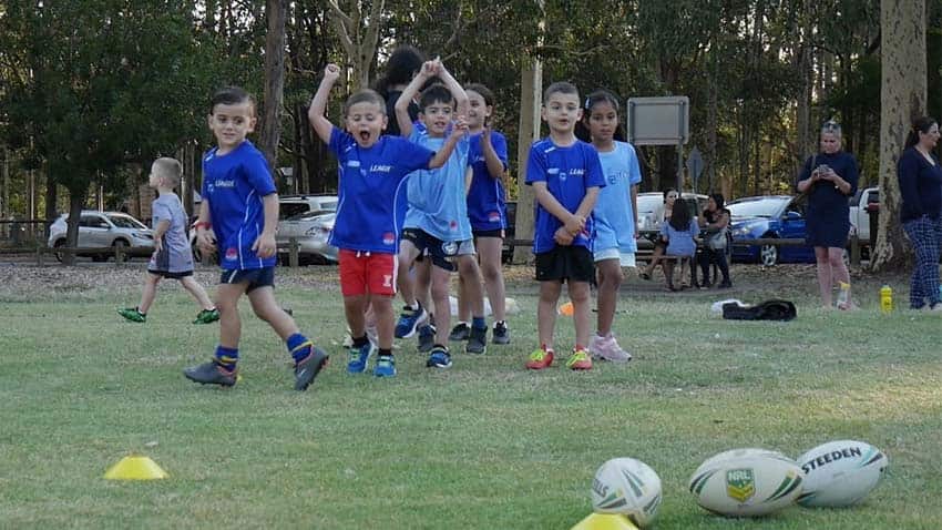 Children of diverse backgrounds play Rugby