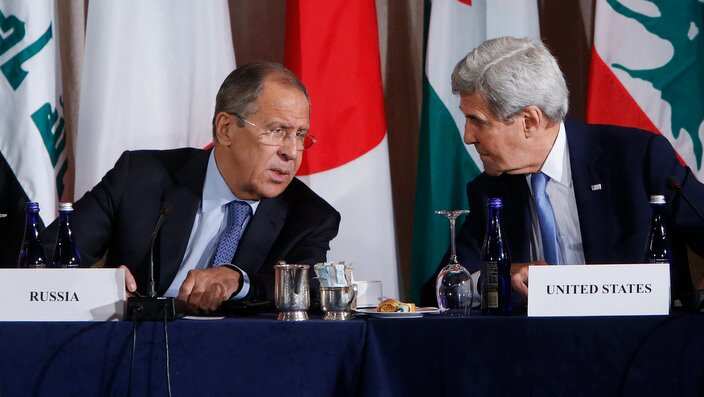 Russia's Foreign Minister Sergey Lavrov, left, and US Secretary of State John Kerry talk during a meeting of the International Syria Support Group in New York