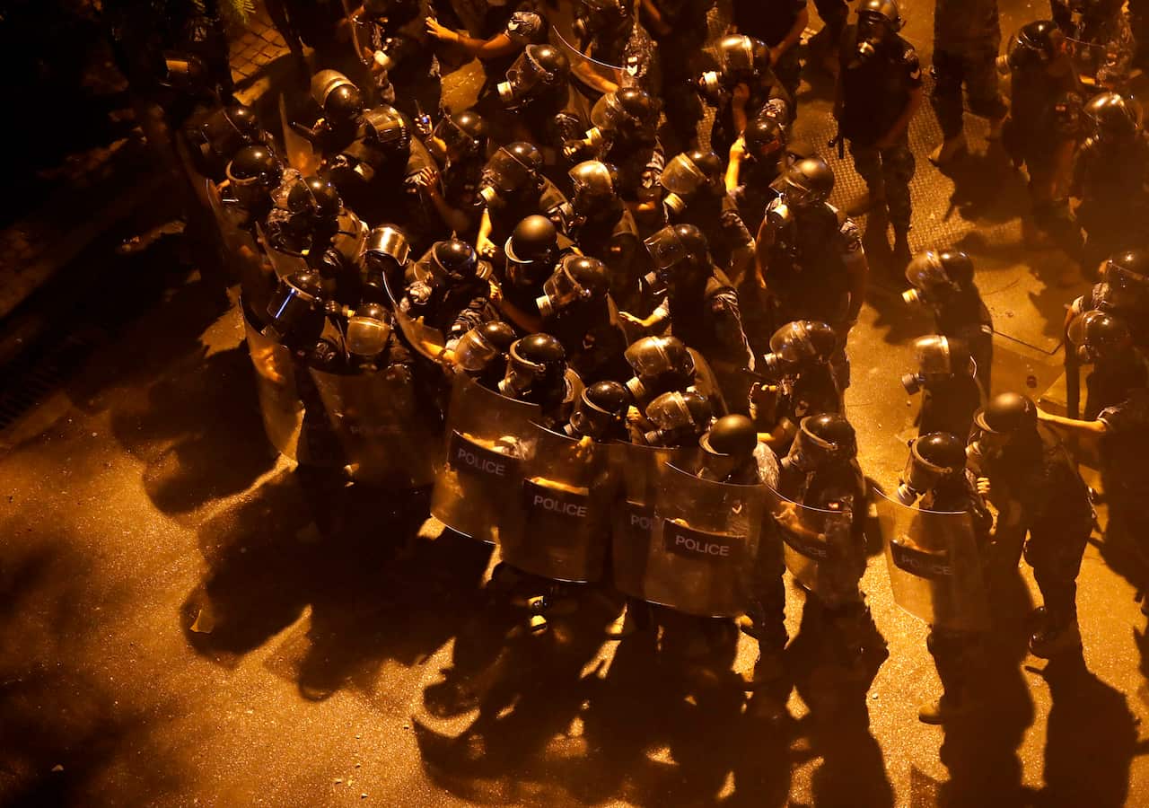 Riot police advance to push back the anti-government protesters from a square near the government house, during a protest Beirut, Lebanon