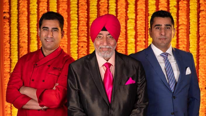 Manjit Gujral (centre) with his sons