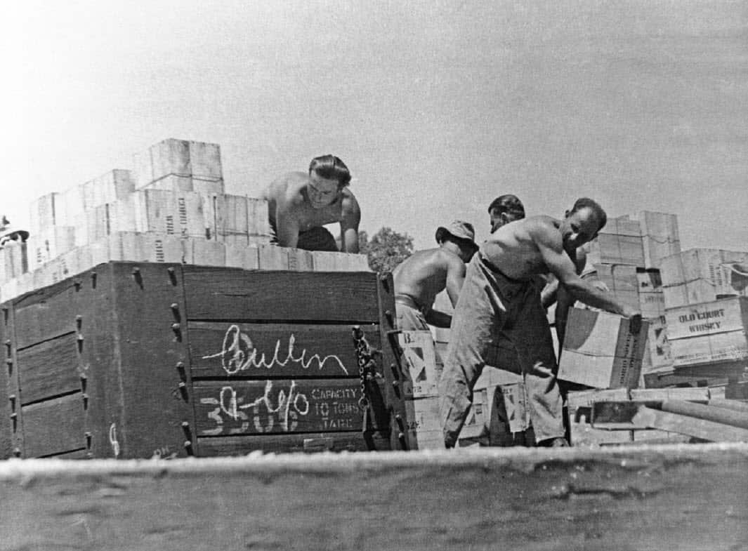 Members of 6th Employment Company unloading railway trucks.