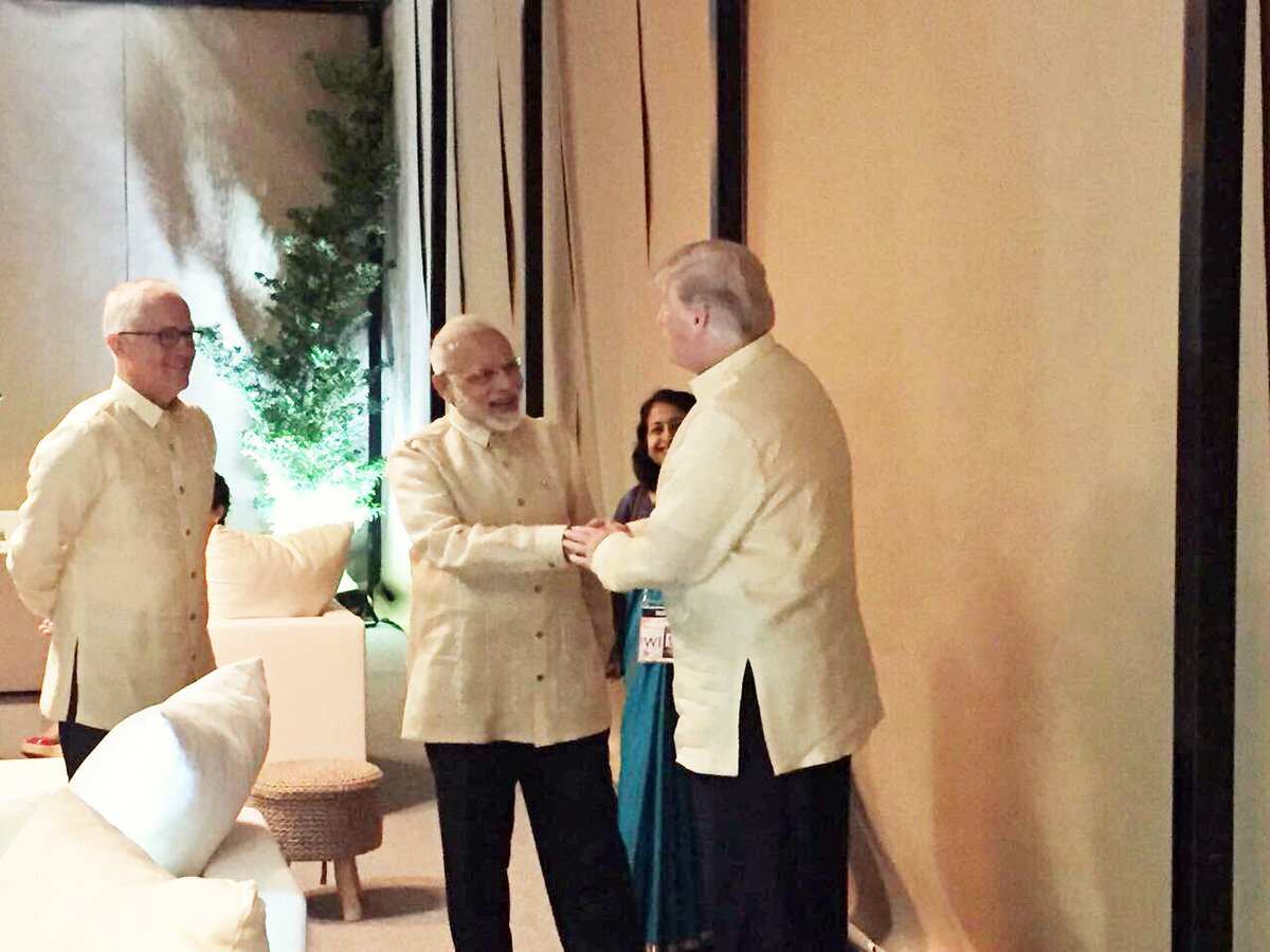 India's Prime Minister Narendra Modi greets US President Donald Trump, as Australia's PM Malcolm Turnbull looks on.
