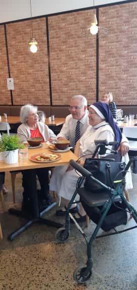 Prime Minister Morrison with customers at a cafe