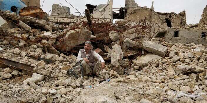 Man in Mosul searching in the remains