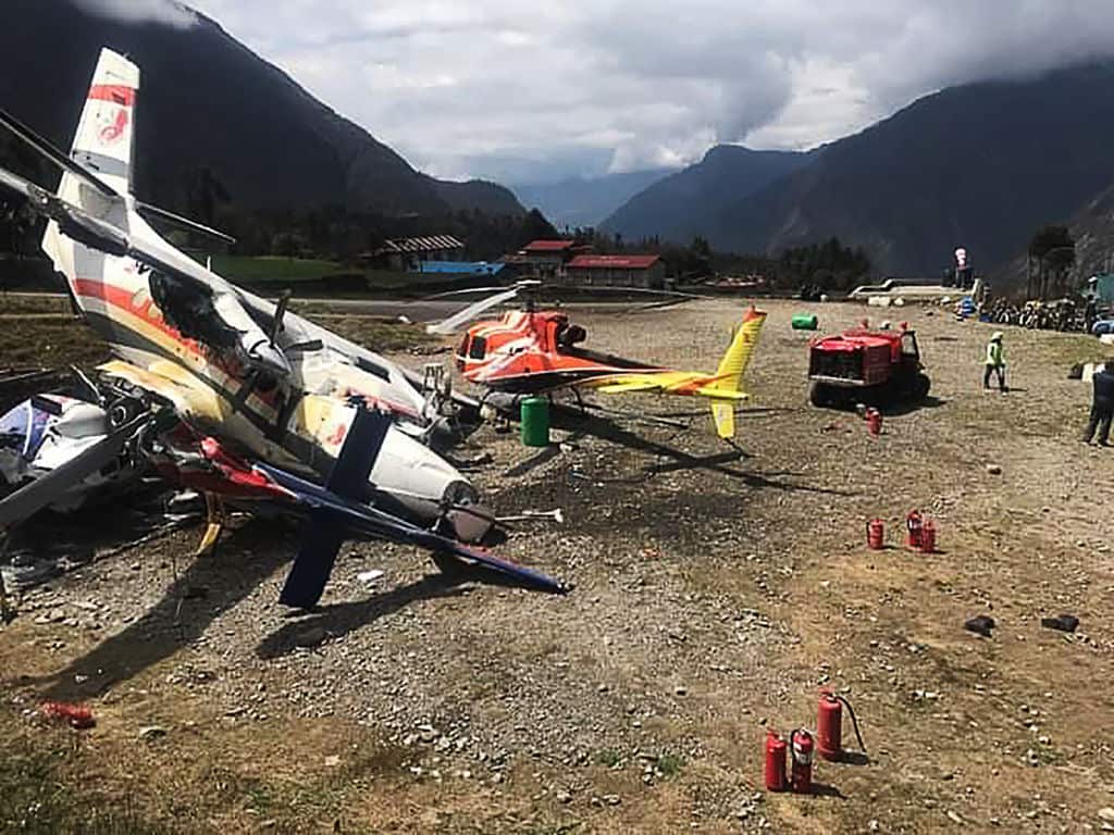 A Summit Air Let L-410 Turbolet aircraft is seen after it hit two helicopters during take off at Lukla airport in Nepal.(Photo by STR/AFP/Getty Images)