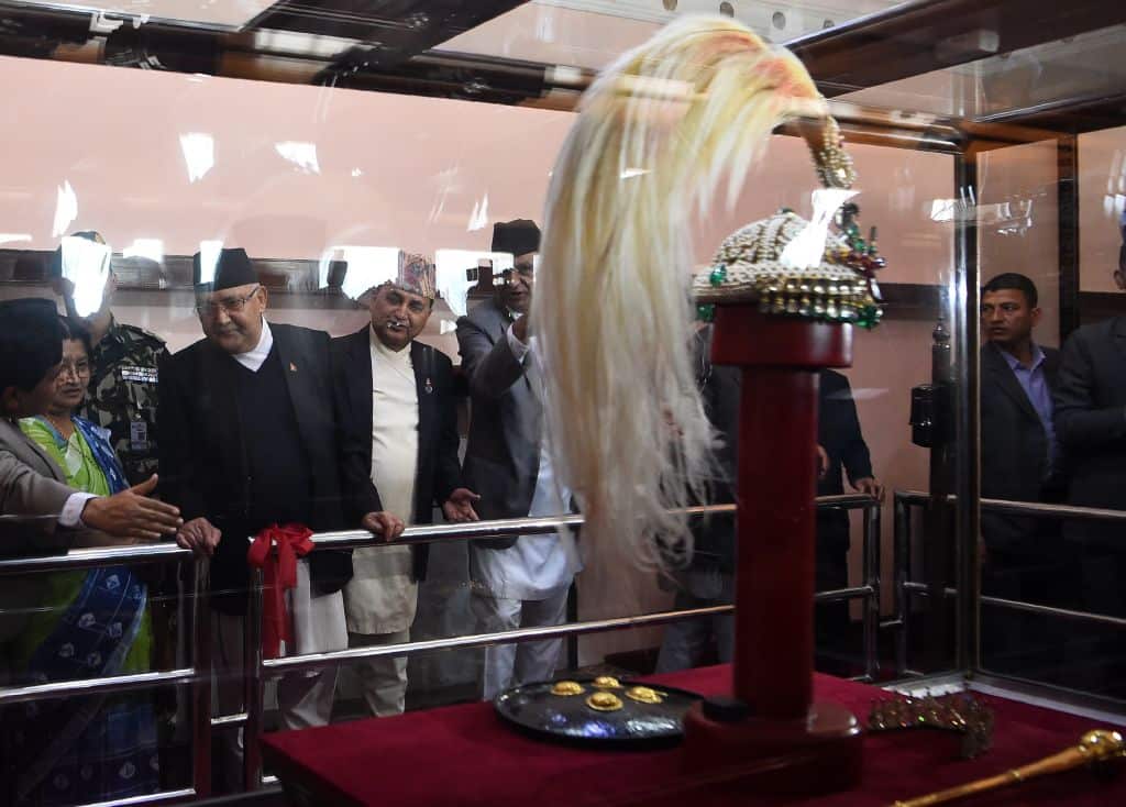 Nepali Prime Minister KP Sharma Oli (3L) looks at the royal crown of Nepal's former monarchs at the Narayanhiti Museum, the former royal palace, in Kathmandu on October 15, 2018
