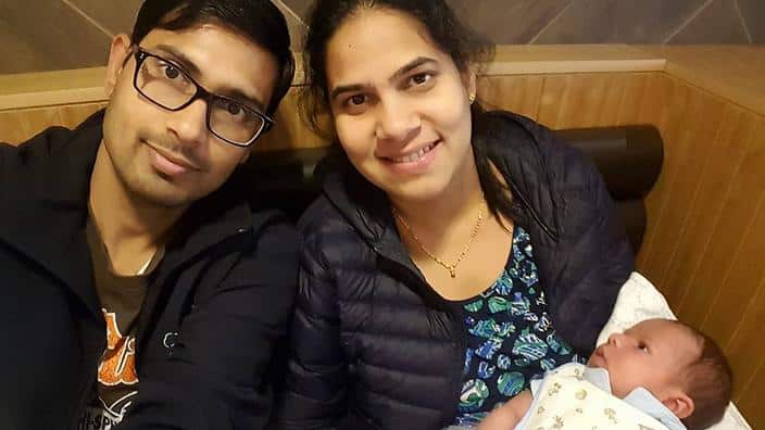Mohan Kumar (left) with his wife, Nethra Krishnamurthy and infant son, Hari.