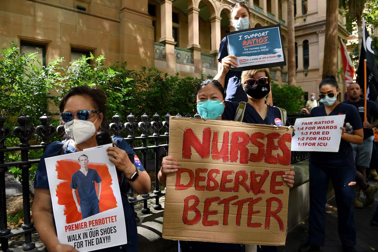 Nurses hold placards during a nurses’ strike outside the NSW Parliament House in Sydney, Tuesday, February 15, 2022