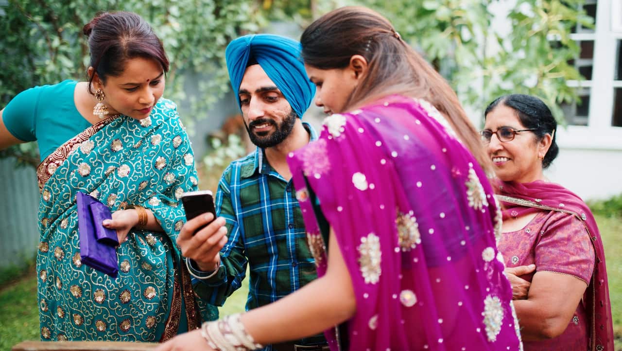 Family using cell phone in backyard