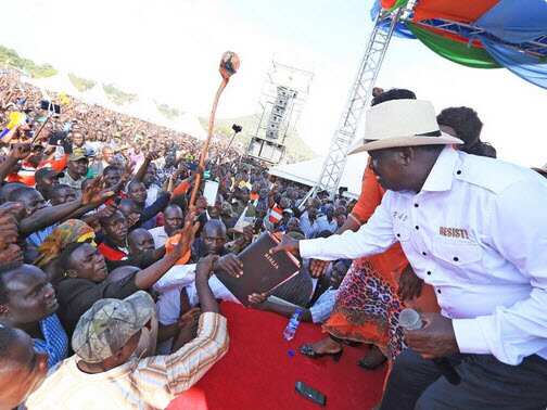 Supporters hand NASA principle Raila Odinga bible for swearing in ceremony
