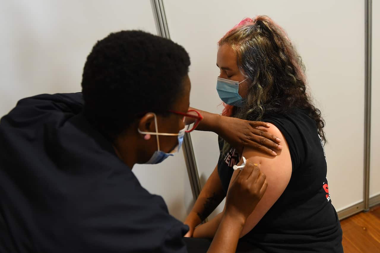 Paramedic Rhiannon Gallatly receives an AstraZeneca COVID-19 vaccination in Melbourne