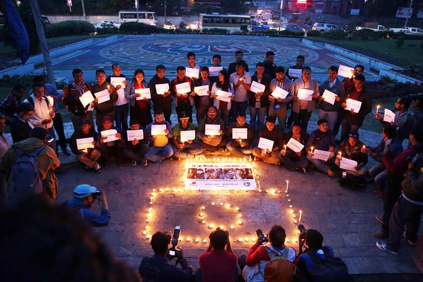 Nepali journalists in attend a candle light vigil in Kathmandu in memory of the 10 journalists killed in Afghanistan.