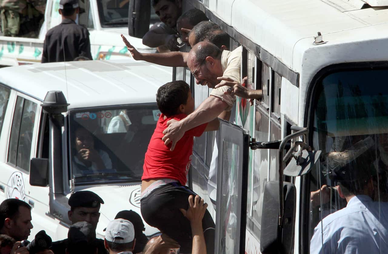 Freed Palestinian prisoners arrive in a bus as they are welcomed by large crowds at the Rafah border crossing between the Gaza strip 