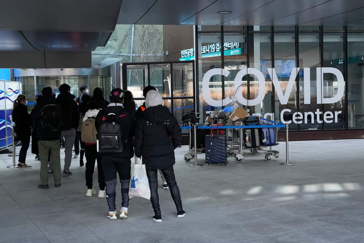 Travelers wait for the coronavirus testing at the Incheon International Airport in Incheon, South Korea, Tuesday, Dec, 7, 2021. (AP Photo/Ahn Young-joon).