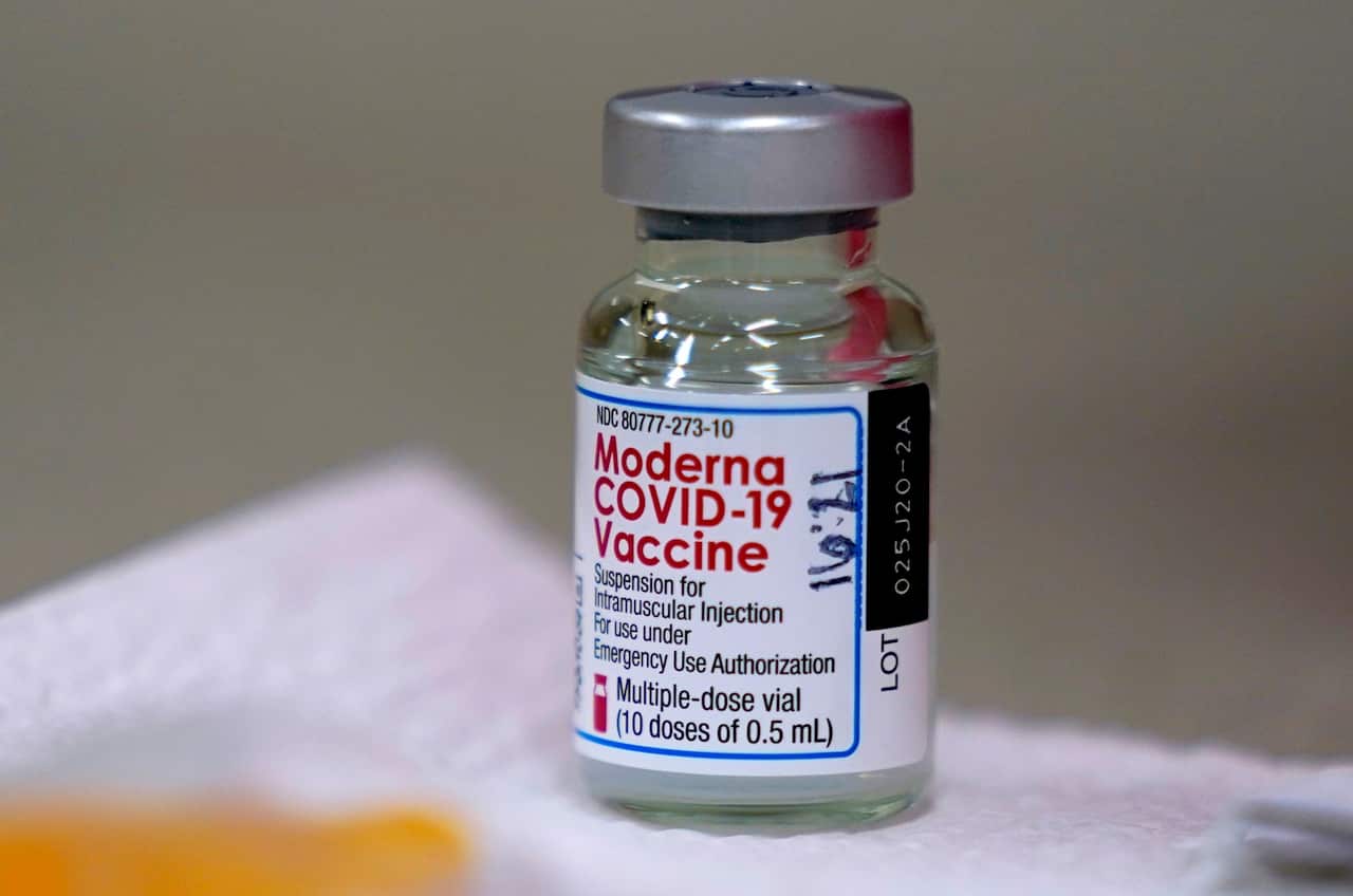 A bottle of Moderna's COVID-19 vaccine is seen on a table before Kansas Democratic Gov. Laura Kelly received an injection Wednesday, Dec. 30, 2020, in Topeka, Kan. (AP Photo/Charlie Riedel)
