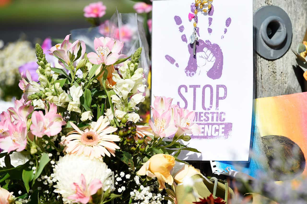 A floral tribute at a domestic violence memorial