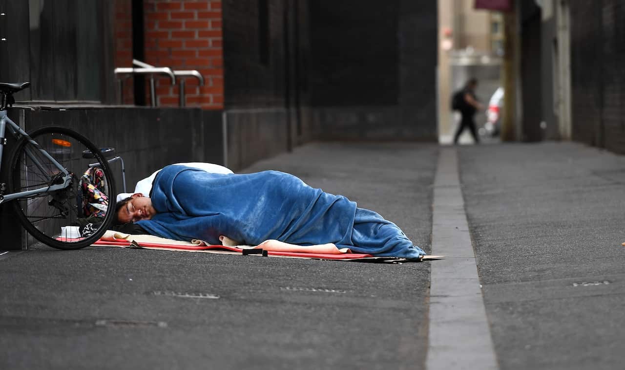 A homeless man sleeps in a laneway in Melbourne