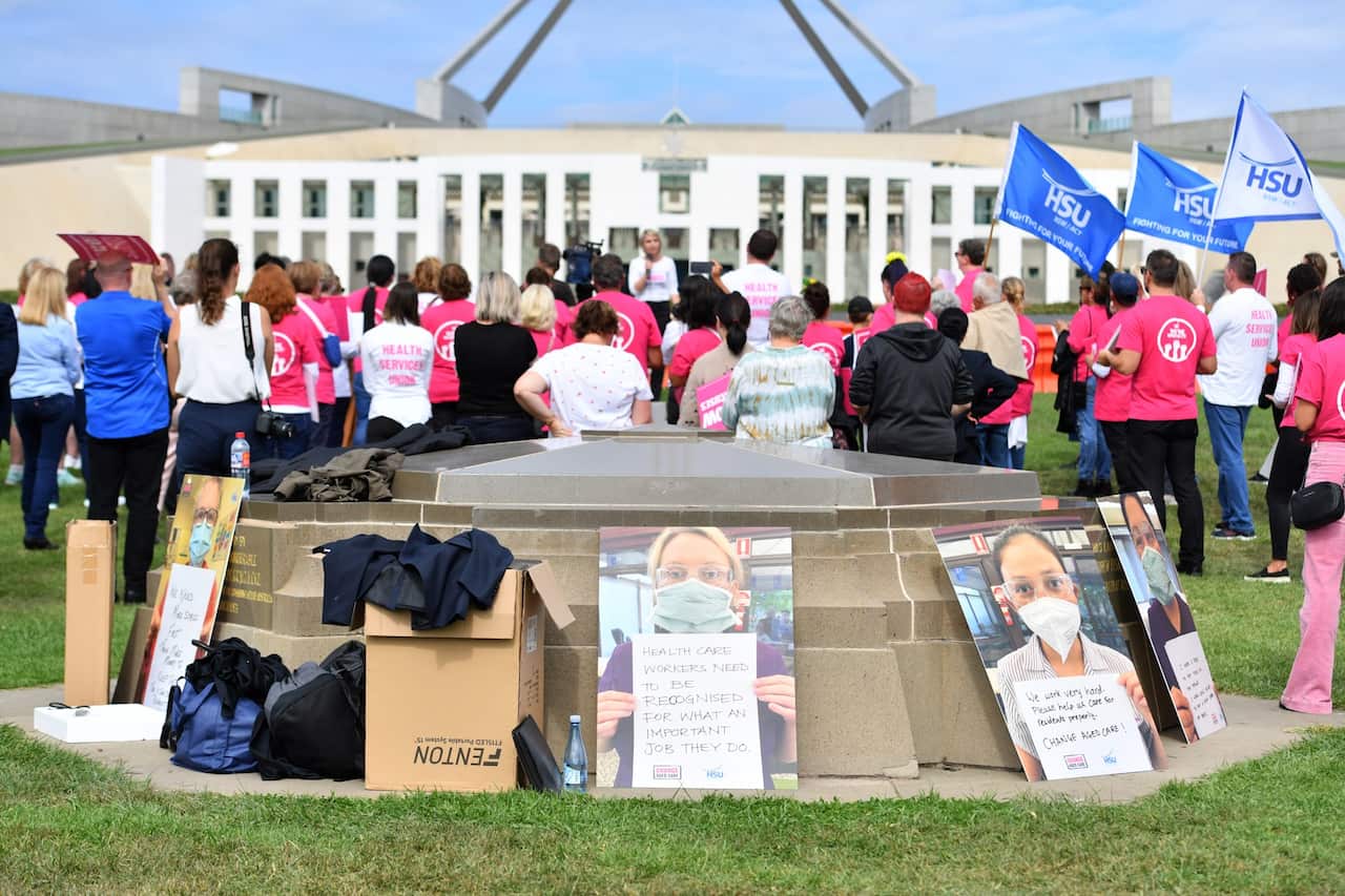 Aged care workers are seen protesting outside Parliament House in Canberra,