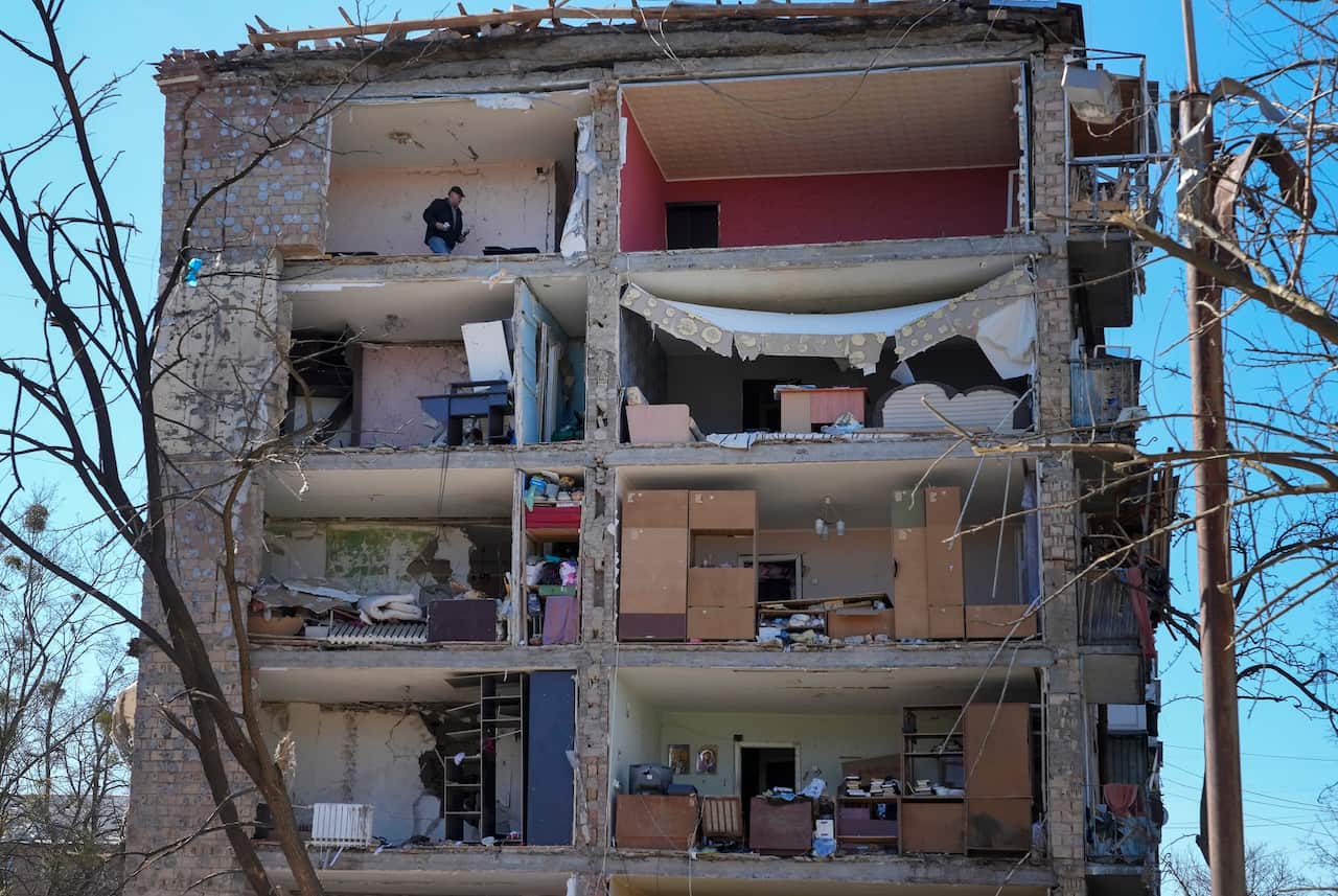 A man walks in his apartment ruined after the Russian shelling in Kyiv.