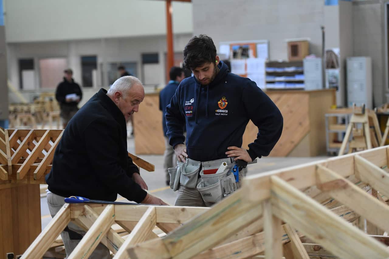 A master and apprentice carpenter are seen at Holmesglen TAFE Chadstone campus in Melbourne