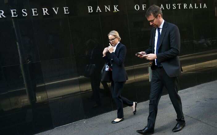 People walk past the Reserve Bank of Australia building