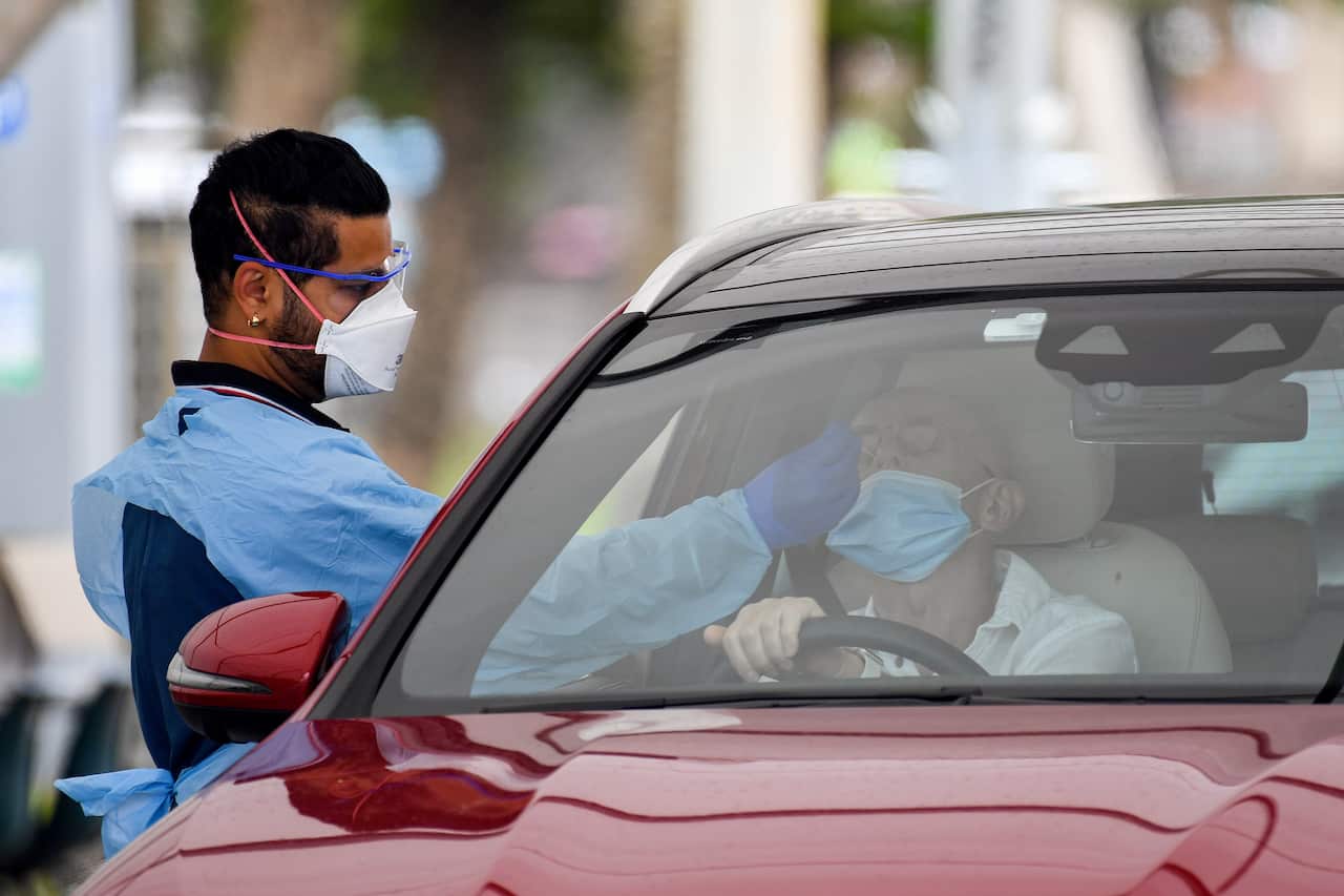 Healthcare workers administer COVID-19 tests at the St Vincent’s Hospital drive-through clinic in Sydney