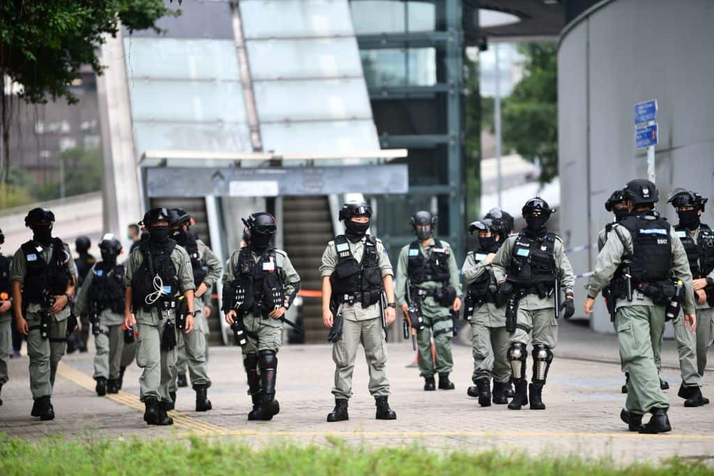 Riot police stand guard outside the Legislative Council in Hong Kong on May 27, 2020, ahead of a debate over a law that bans insulting China's national anthem, (Photo by Anthony WALLACE / AFP) (Photo by ANTHONY WALLACE/AFP via Getty Images)