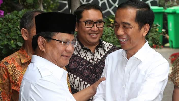 Indonesia's President-elect Joko Widodo, right, greets his political rival Prabowo Subianto during a meeting in Jakarta, Indonesia.