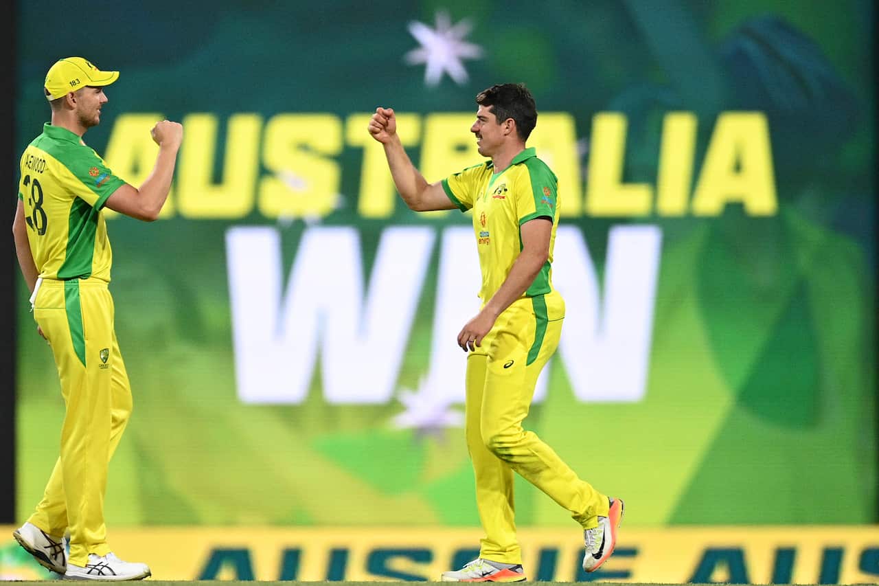 Josh Hazelwood (left) and Moises Henriques of Australia celebrate follwing their win in the second ODI cricket match between Australia and India at the SCG in Sydney, Sunday, November 29, 2020. (AAP Image/Dan Himbrechts)