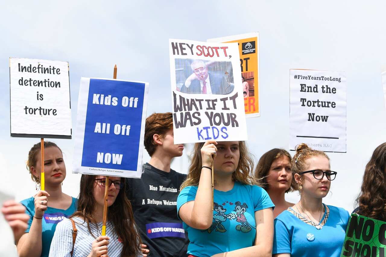 Protesters demand the resettlement of children held on Nauru, outside Parliament House in Canberra on 27 November.