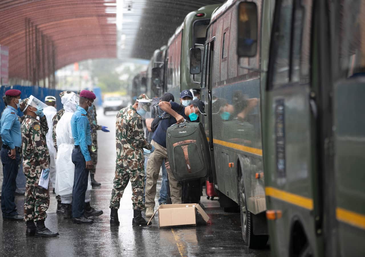 Nepalese people evacuated from Afghanistan arrive via Kuwait at the Tribhuvan International Airport in Kathmandu, Nepal, Tuesday, Aug. 17, 2021. (AP Photo/Niranjan Shrestha)