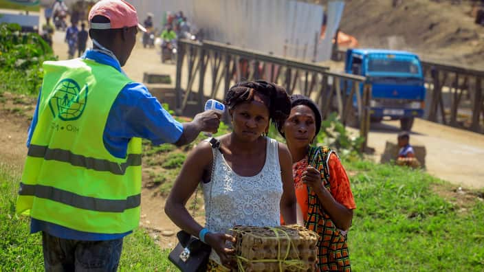 People are being checked for Ebola virus at crossing near Kasindi