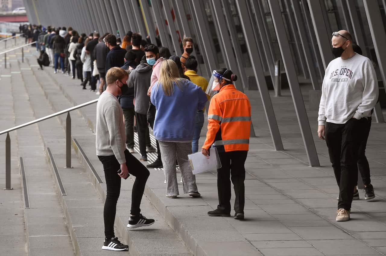 People form long queues outside a vaccination centre in Melbourne