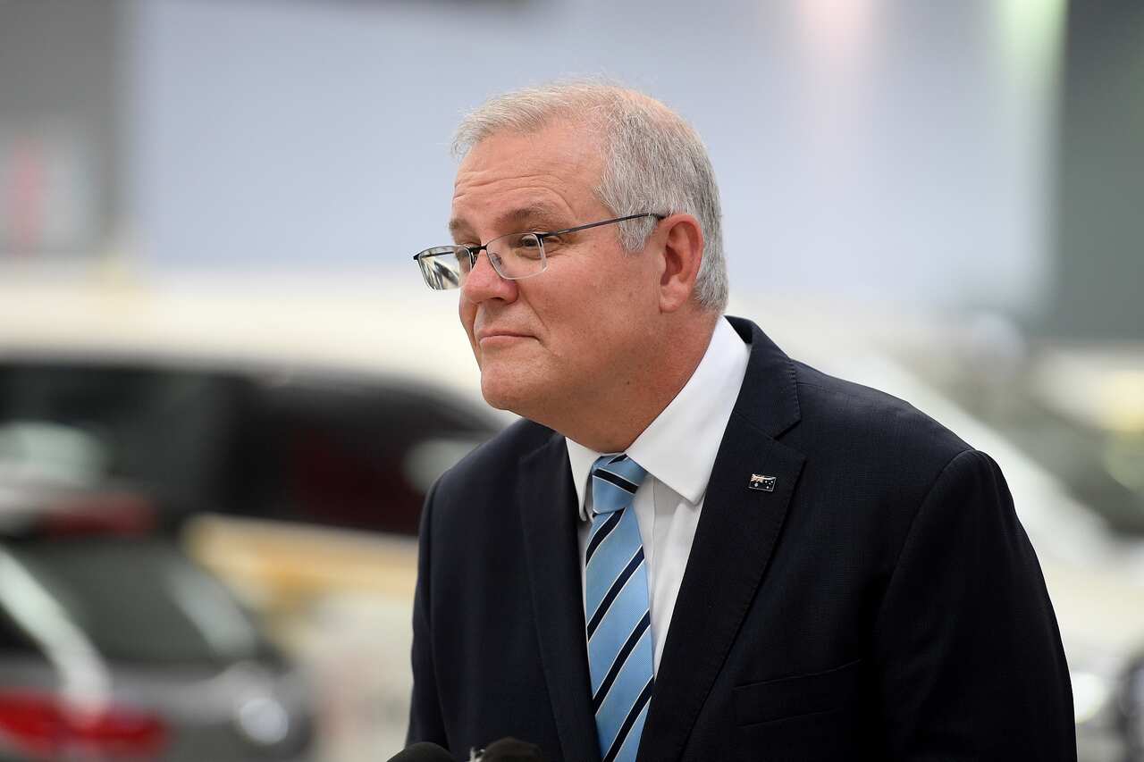 Australian Prime Minister Scott Morrison speaks to media during a visit to the Phil Gilbert Motor Group car delalership in Sydney, Friday, March 12, 2021. (AAP Image/Dan Himbrechts) NO ARCHIVING